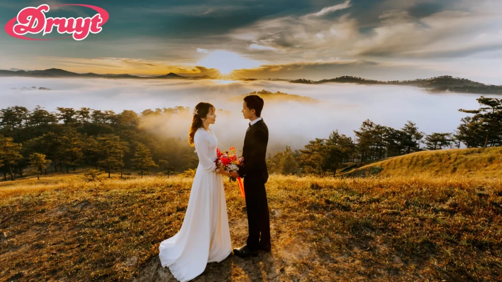 A newlywed couple sitting on a wooden platform, sharing a quiet moment together in a forest. Can you get invited to a wedding? Close friends and family are usually prioritized for invites.